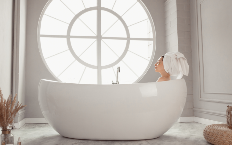 a woman sits in a bathtub